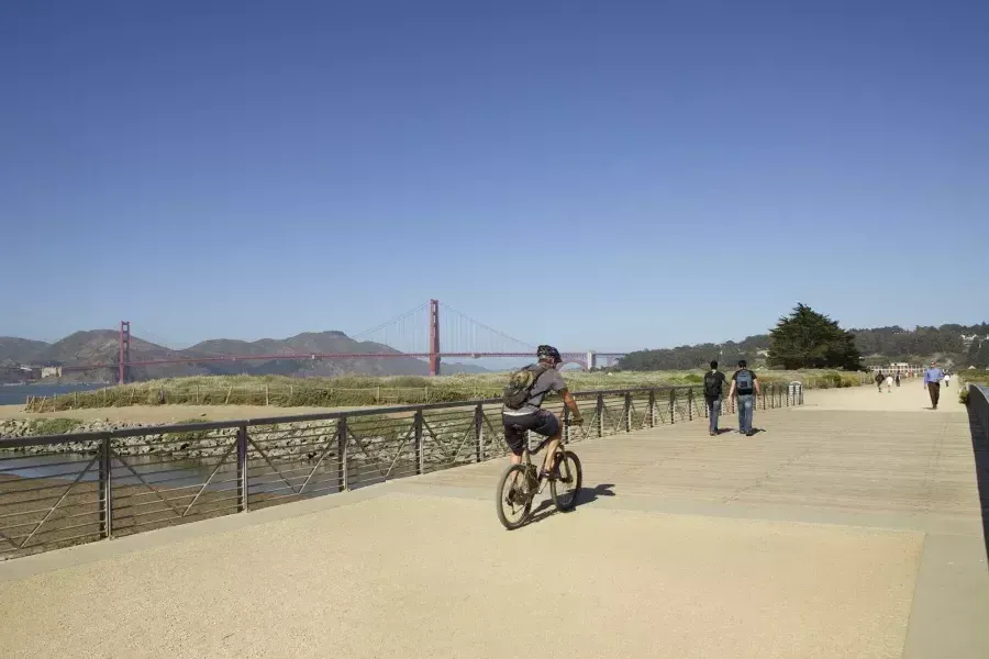 Um homem anda de bicicleta por uma trilha em Crissy Field. 贝博体彩app, 加州.