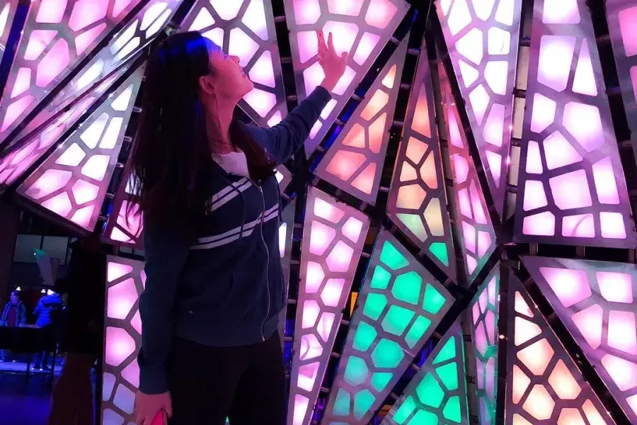 Woman interacting with exhibit at Exploratorium 