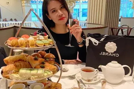 Woman drinking and having tea at Rotuna in Neiman Marcus